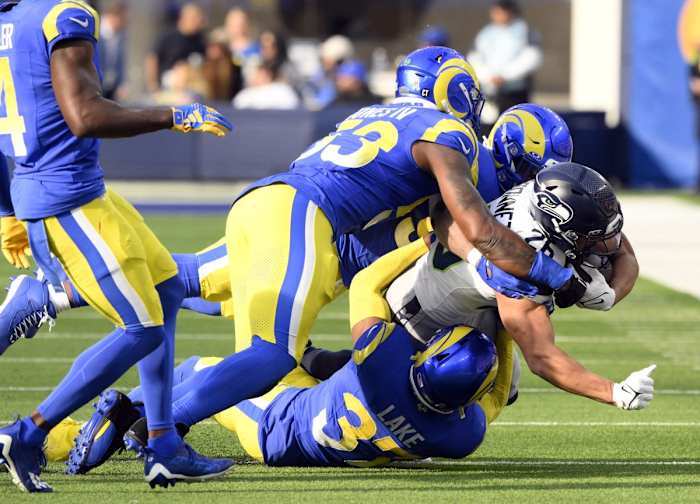 Nov 19, 2023; Los Angeles Rams linebacker Ernest Jones (53) and safety Quentin Lake (37) tackle Seattle Seahawks running back Zach Charbonnet (26). Mandatory Credit: Robert Hanashiro-USA TODAY Sports